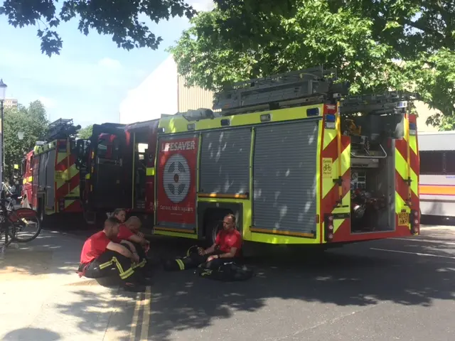 Firefighters taking a break in Booker Road, at the back of the Grenfell Tower fire