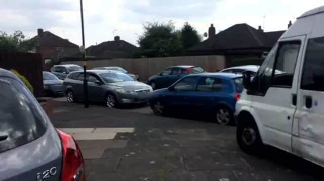 Cars parked on the pavement