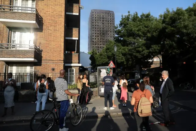 People looking at Grenfell Tower