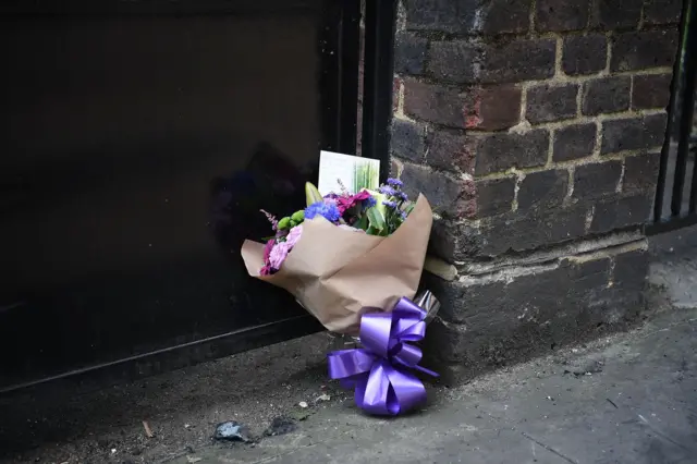 A bunch of flowers are left on the ground near Grenfell Tower block in Latimer Road