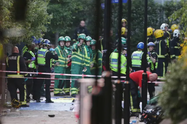 Members of the emergency services work at the scene