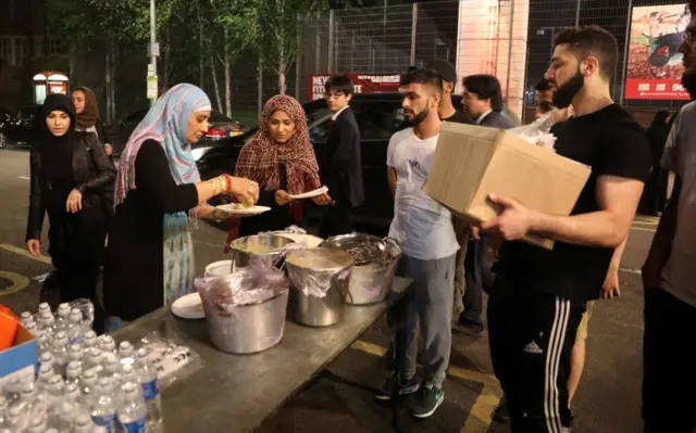 Food is distributed near the tower block