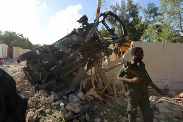 A security person stands guard at the scene of an attack outside a hotel and an adjacent restaurant in Mogadishu, Somalia June 15, 2017.