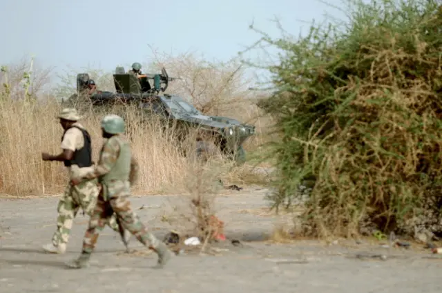 Nigerian soldiers patrol in the north of Borno state close to a Islamist extremist group Boko Haram former camp on June 5, 2013 near Maiduguri.