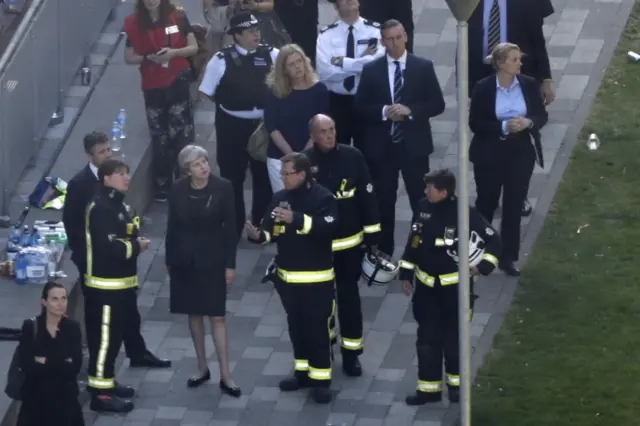 British Prime Minister Theresa May visits the remains of Grenfell Tower on 15 June