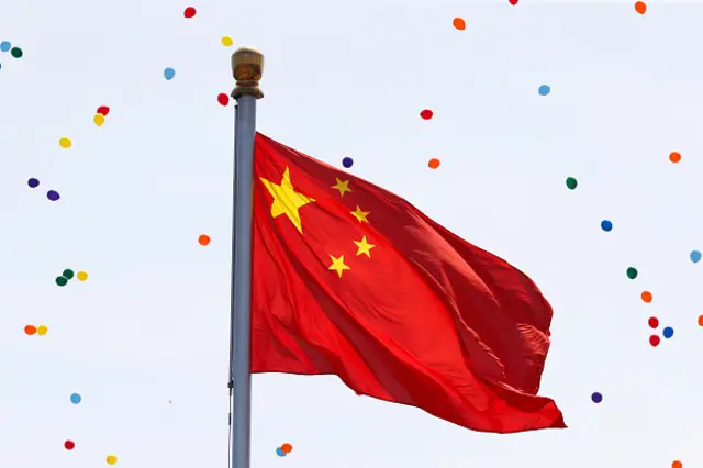 Released balloons fly around the China national flag during a military parade marking the 70th Anniversary of the 'Victory of Chinese People's Resistance against Japanese Aggression and World Anti-Fascist War' at Tiananmen Square on September 3, 2015 in Beijing, China.