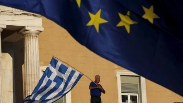 Man carrying Greek flag