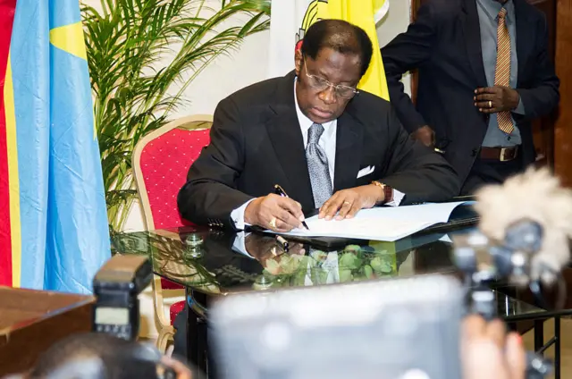 Democratic Republic of Congo Minister of Justice Alexis Thambwe Mwamba signs an accord at the inter diocesan centre in Kinshasa on January 1, 2017 following months of talks brokered by the Roman Catholic Church between the government and opposition