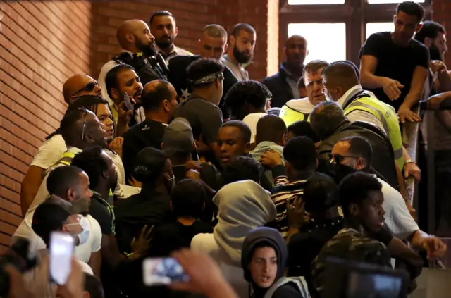 A crowd gathered on a stairwell in Kensington Town Hall