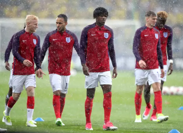 England players warm up in the rain