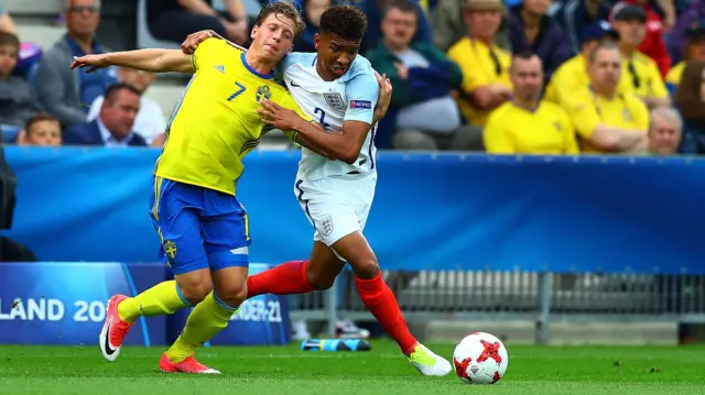 Mason Holgate of England and Alexander Fransson of Sweden in action