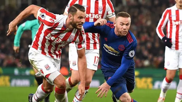 Erik Pieters of Stoke City (L) and Wayne Rooney of Manchester United (R) battle for possession in January