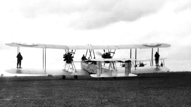 Two parachutists stand on the wings of an RAF Vickers Vimy at Henlow Air Pageant, Henlow, Bedfordshire