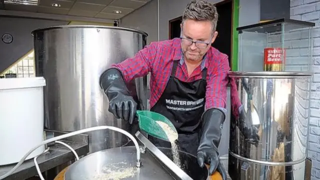 Tamworth Brewing Co. owner George Greenaway pours malt