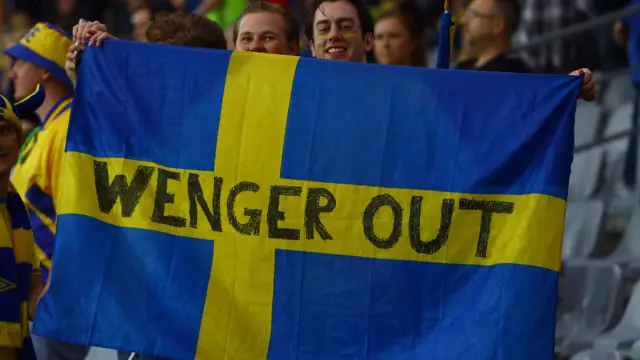 Sweden fans with a Wenger out banner