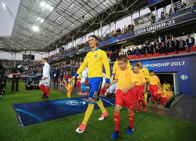 Sweden's Kristoffer Olsson leads his team out