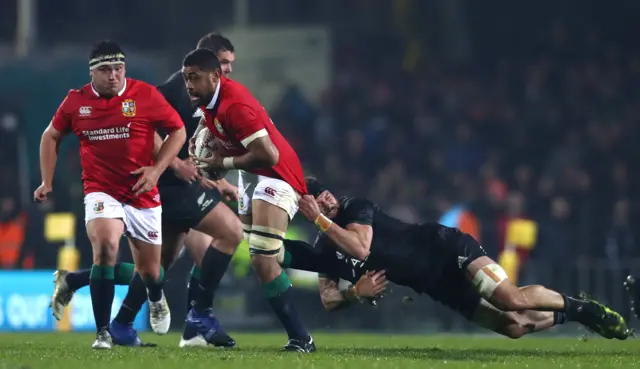 Taulupe Faletau of the Lions tackled by Elliot Dixon of the Maori All Blacks