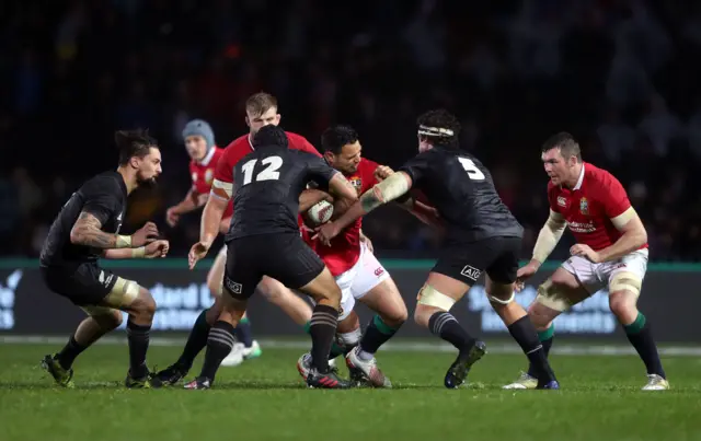 Ben Te"o is tackled by Maori All Blacks" Charlie Ngatai (left) and Thomas Franklin