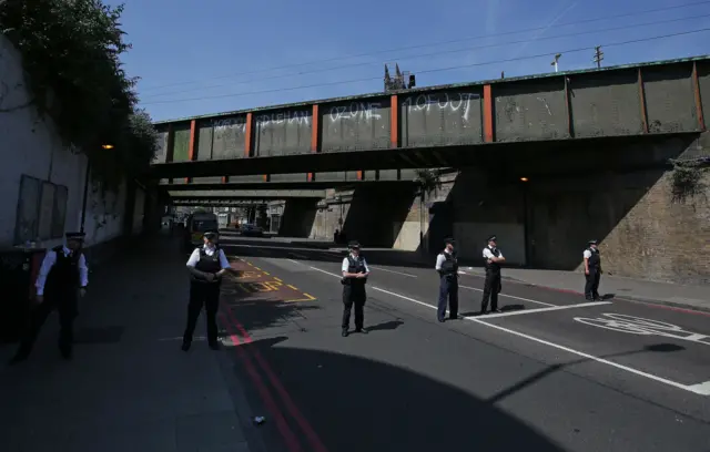 Officers take part in a minute's silence for the Grenfell Tower fire victims