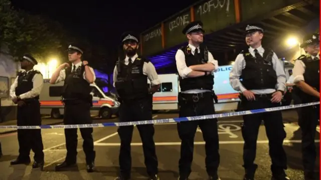 Police officers stand guard