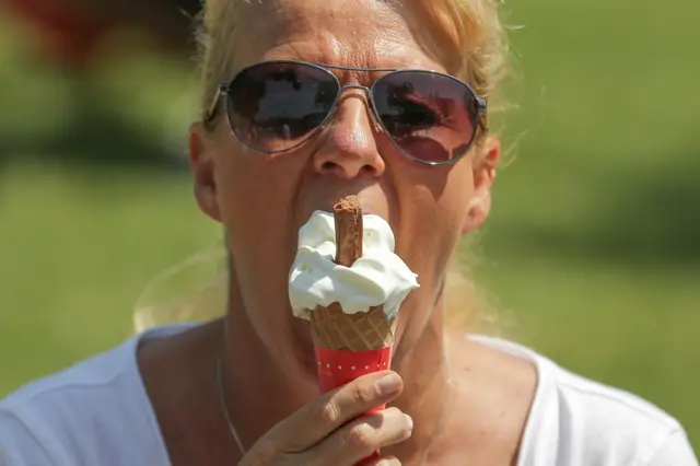 A woman eats an ice cream