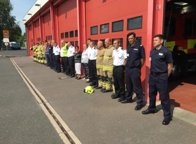 Fire fighters stood in silence