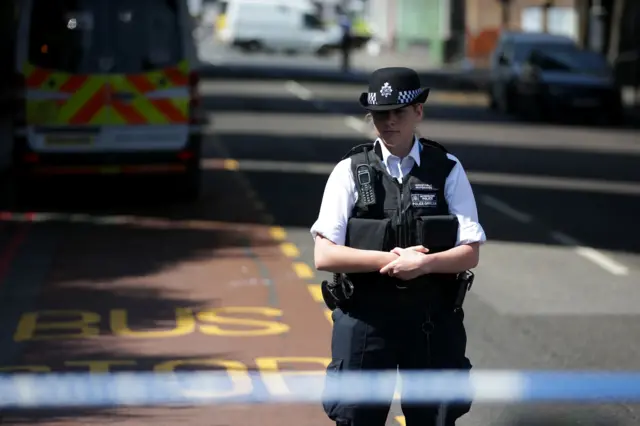 Officers take part in a minute's silence for the Grenfell Tower fire victims