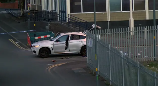 Car at scene near police cordon