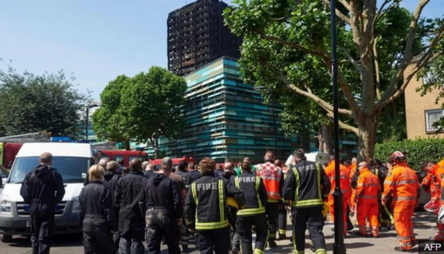 Firefighers held a minute's silence by the towerblock