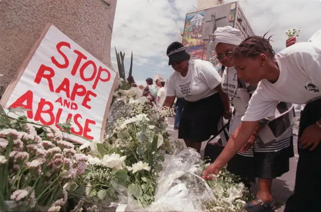 Women place white flowers outside parliament during a demonstration in Cape Town 25 November 1999, the International Day for the Prevention of Violence against Women. South Africa has a high incidence of rape with more than 50 000 reported rapes per year