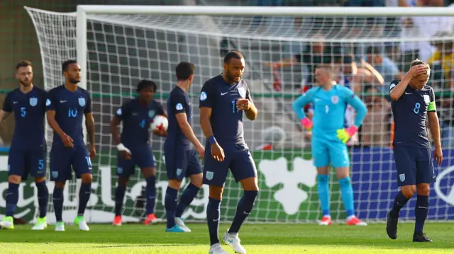 England players look dejected after conceding the opening goal