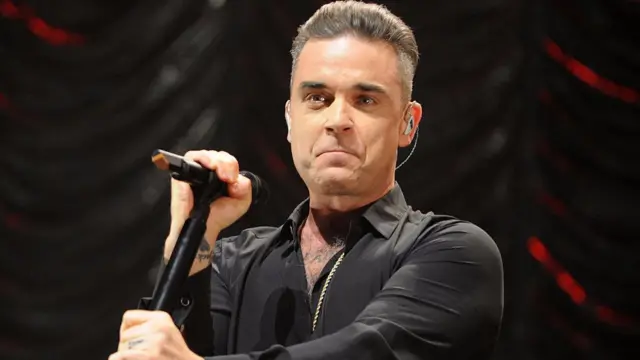 Robbie Williams performing