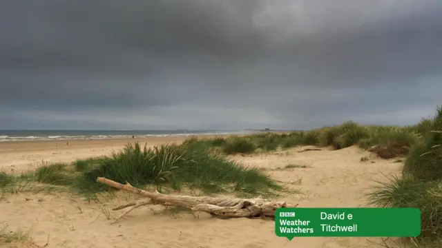 Dark skies over sandy beach