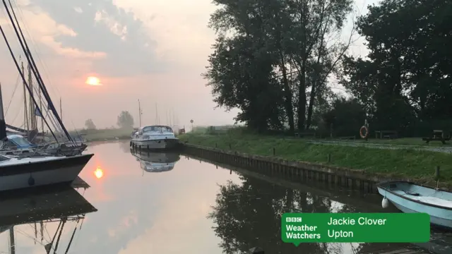 Sunrise over Broadland scene, with moored boats