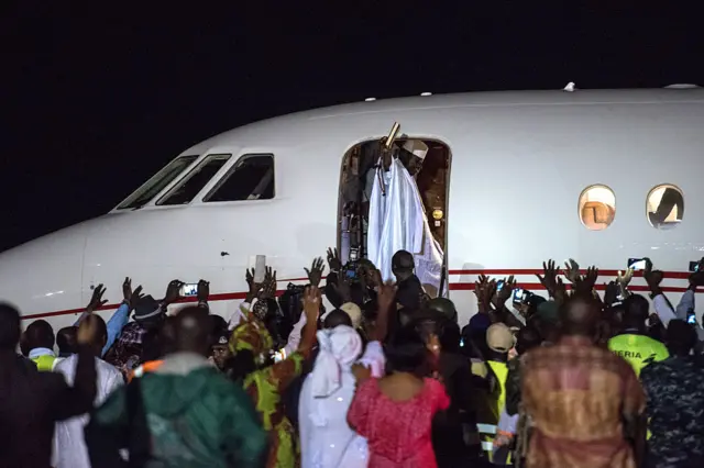 Ex-President Yahyah Jammeh waves to a crowd of supporters before leaving the country on January 21, 2017