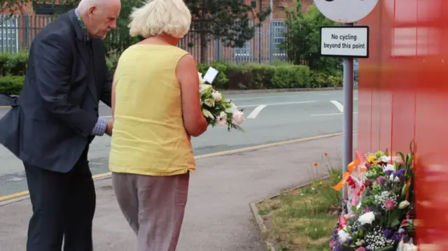 Cllr Paul Bates, cabinet member for finance and communities at Cheshire East Council, and Crewe Mayor Diane Yates laying flowers near to the site.