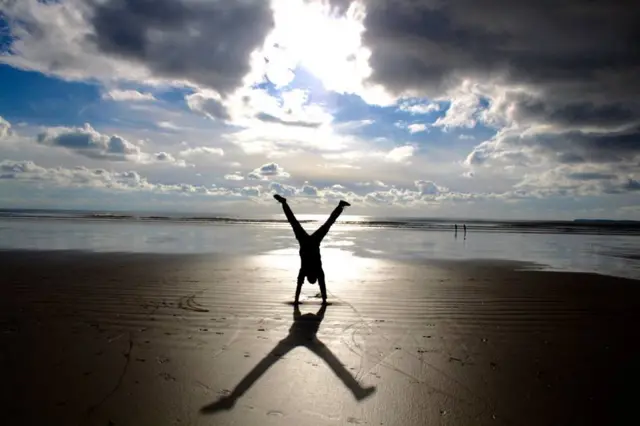 Handstand at Pendine Sands, Carmarthen Bay, Wales