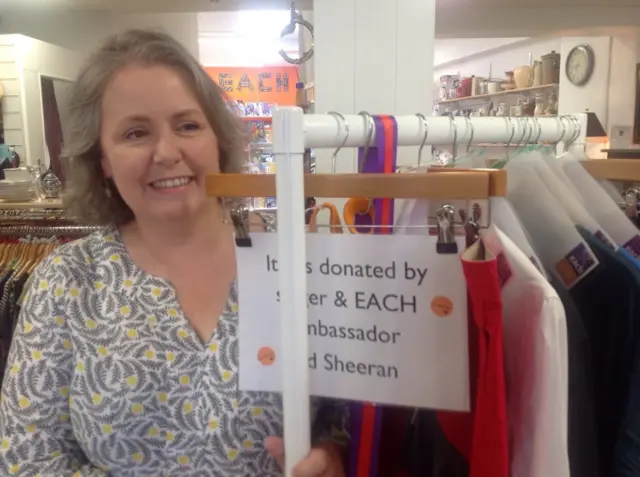 Sarah Throssell stands by a rail of Ed Sheeran's clothing