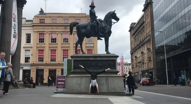 Handstand at the Duke of Wellington statue in Royal Exchange Square, Glasgow