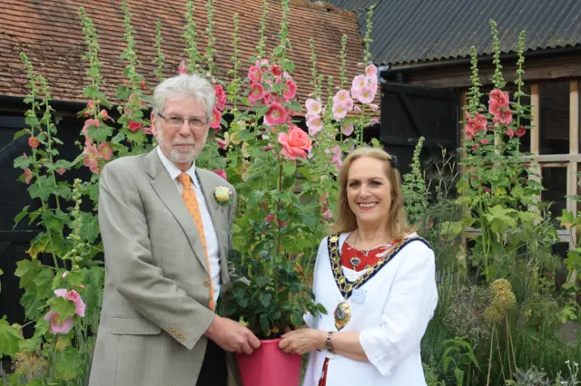 Council chairwoman Zoe Patrick presented the rose bush to the Earth Trust's Graham Shaw