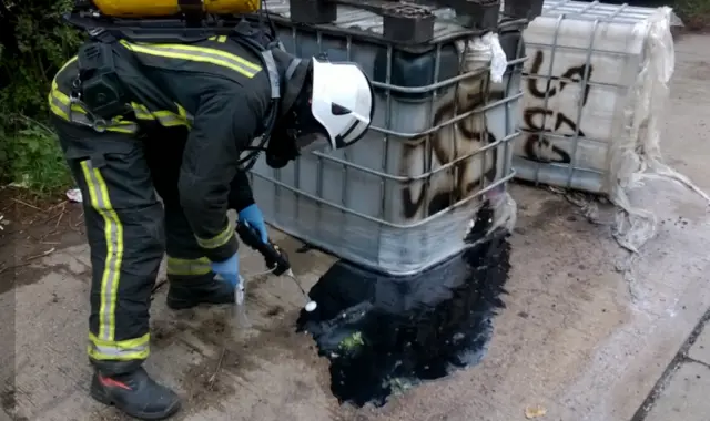 Firefighter testing chemicals at side of A57 in Sheffield