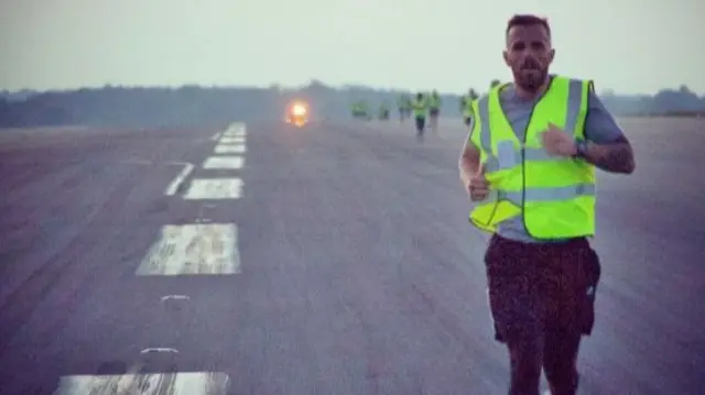 Runner running down London Luton Airport runway.