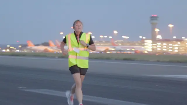 Runner running down London Luton Airport runway.