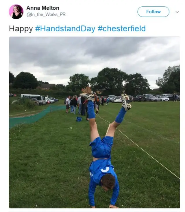 Boy in football kit doing handstand