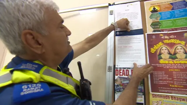 Police putting up scam warning poster