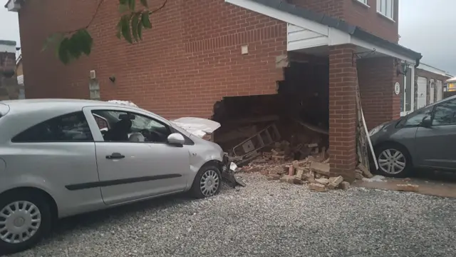 Car crashed into house