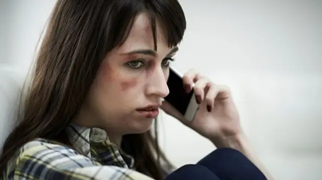 Domestically abused woman on the phone