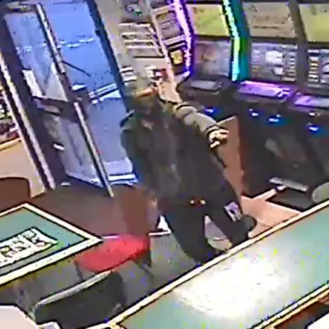 armed robber holds up bookmakers