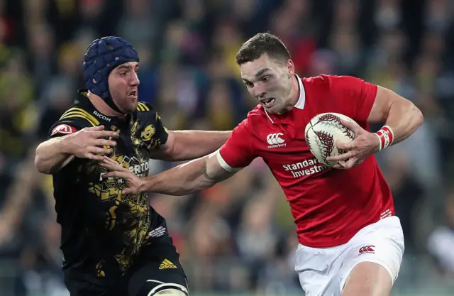 George North hands off a player