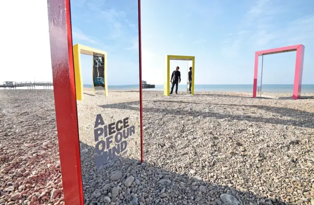 Mirrored beach hut and doorways on Worthing beach